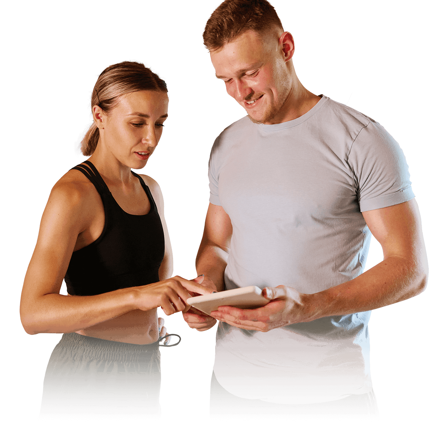 A man in a gray t-shirt and a woman in a black top looking at a tablet together.