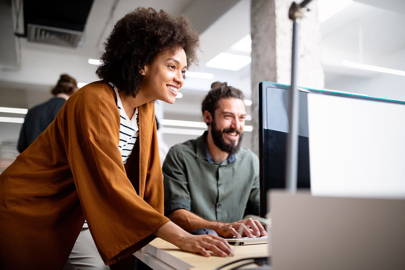 A woman and a man brainstorming together to showcase Daxko's nonprofit digital marketing team discovering opportunities for growth.