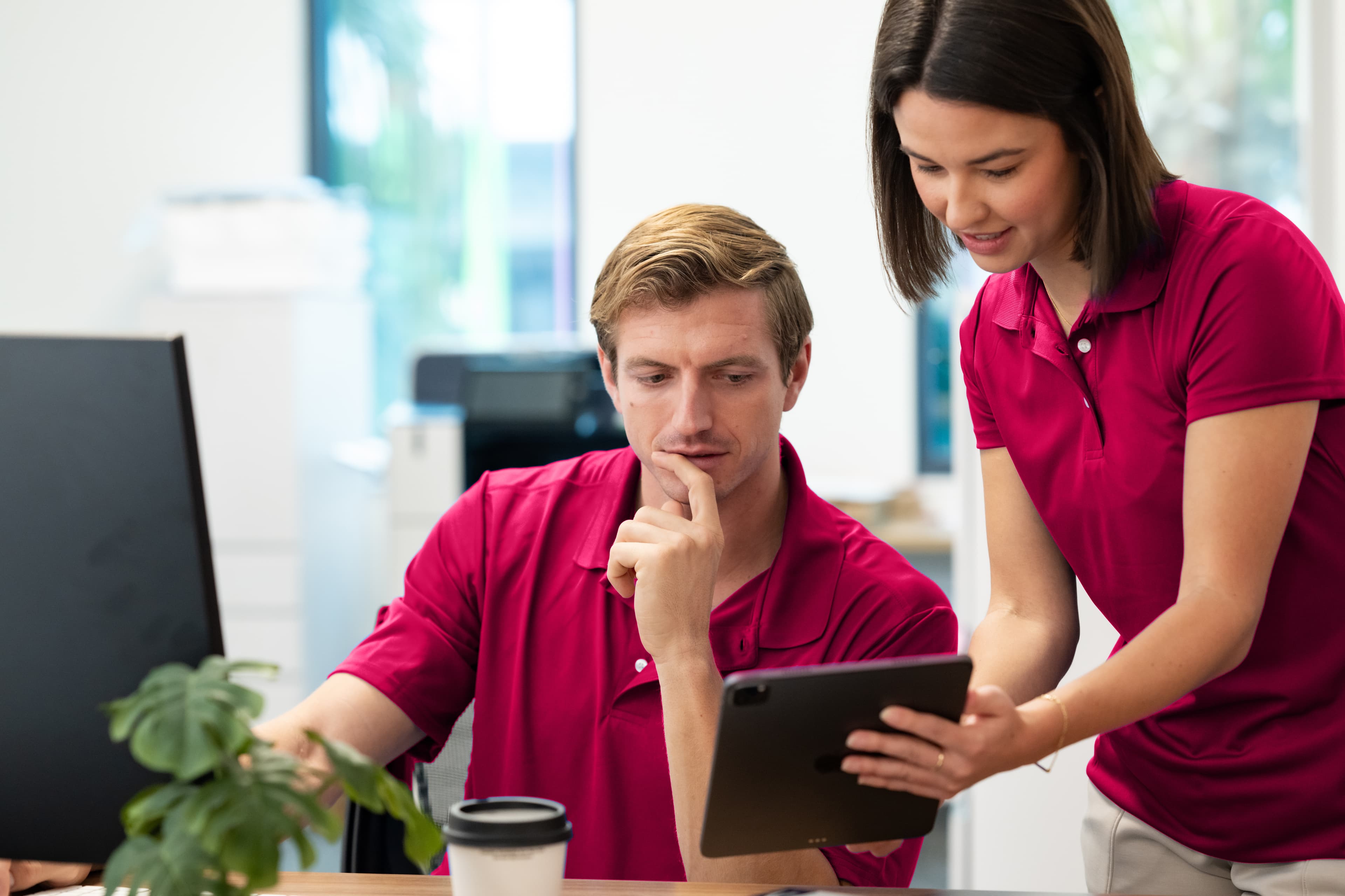 Front desk staff at a nonprofit community center assisting members during peak season registration.