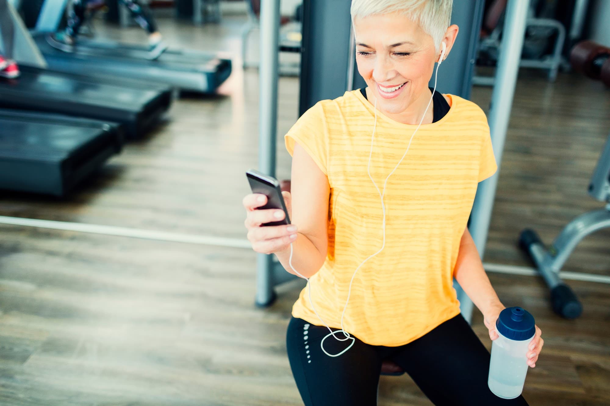Mobile app interface showing class booking and notifications for nonprofit wellness centers.