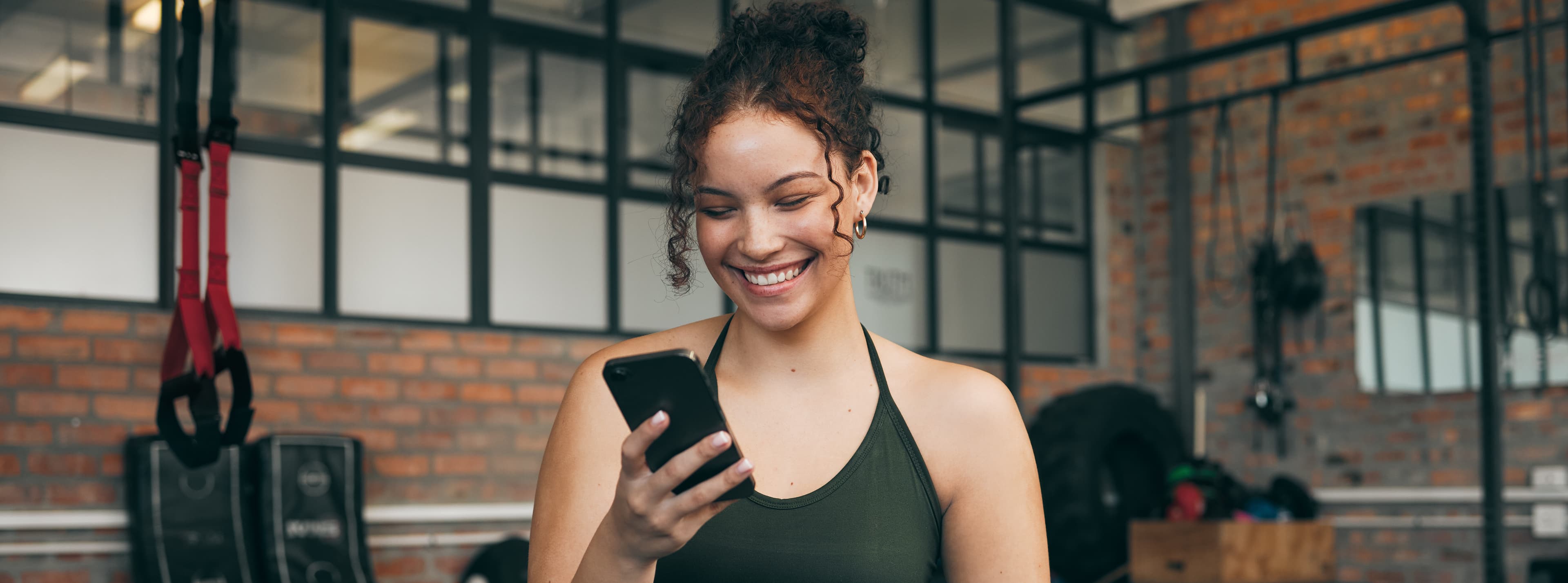 a person checking the mobile app at the gym