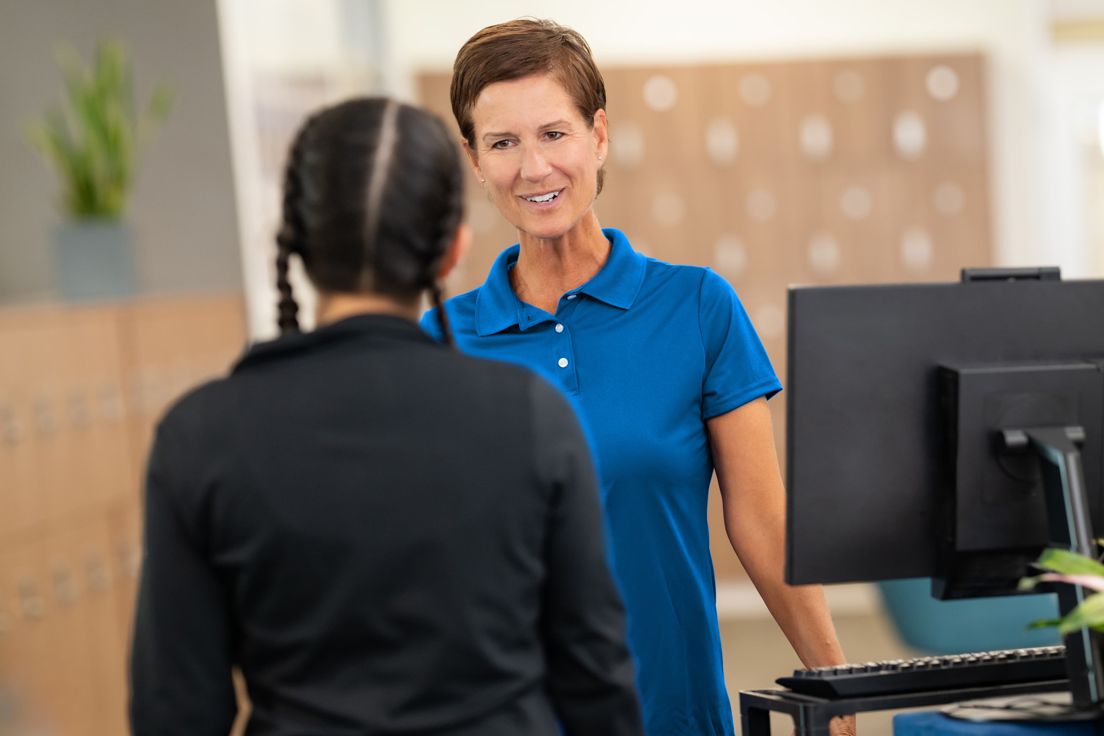 Nonprofit finance and operations leaders reviewing financial reports and reconciliation dashboards in a community center office.