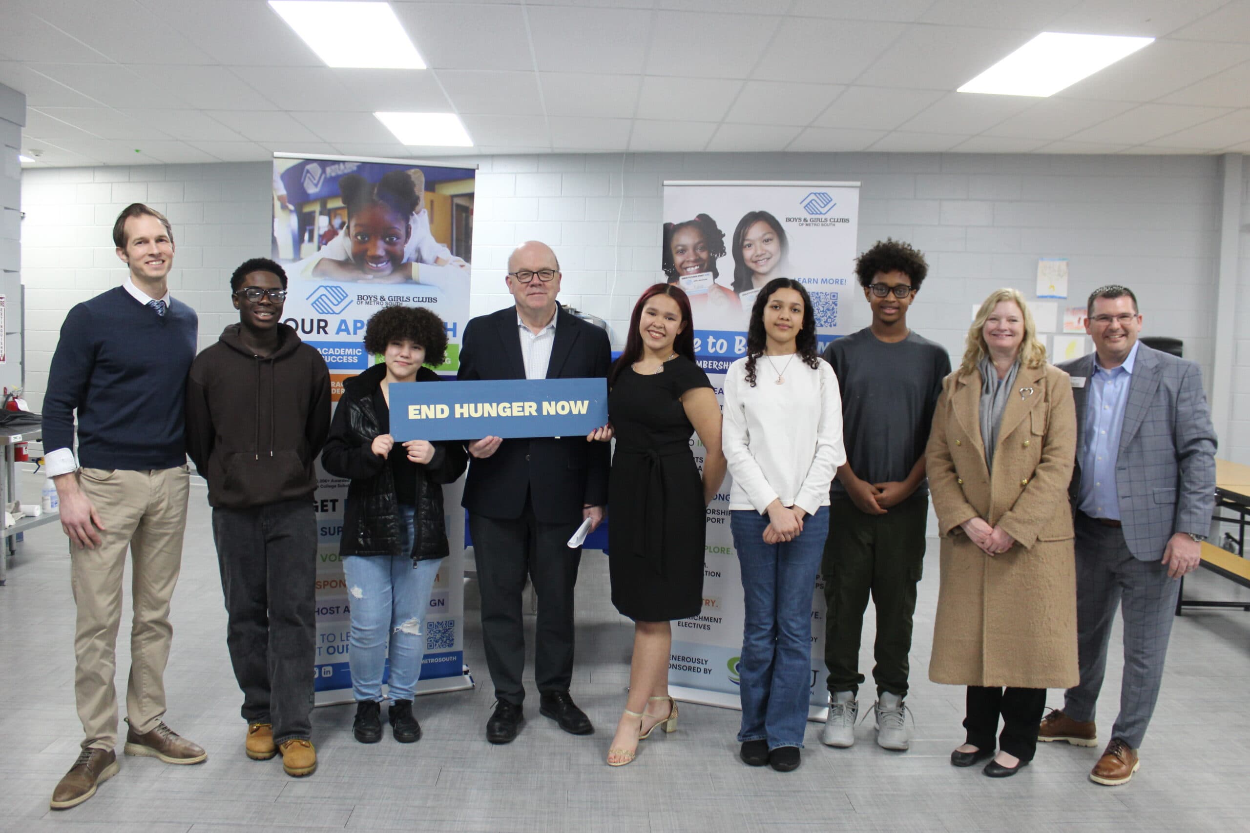 Group photo of Rep. McGovern, Rep. Auchincloss, Derek Heim, staff, and Teen Ambassadors at Boys & Girls Clubs of Metro South